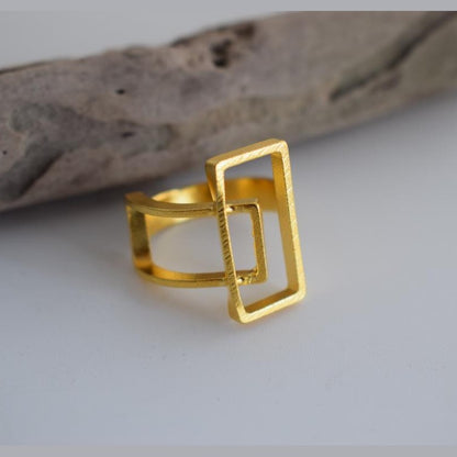 Geometria ring Greek hammered jewelry with rectangular openwork design, available in gold, silver, and rose gold plated.