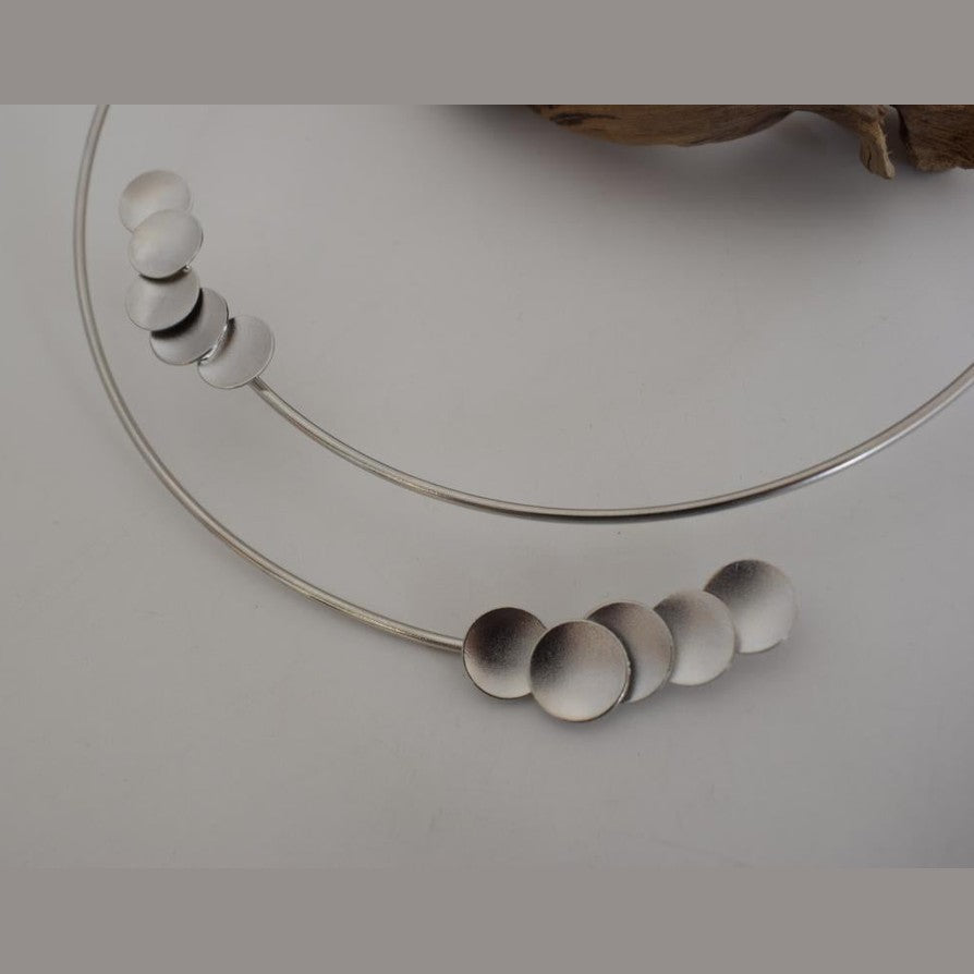 Mycenae necklace in Greek hammered disc design, worn as a minimalist choker and available in 18K gold plated and 18K silver plated finishes.