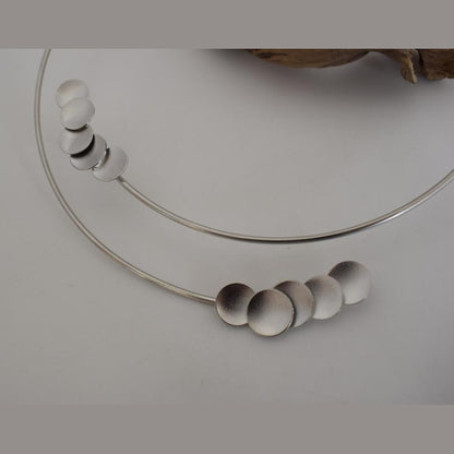 Mycenae necklace in Greek hammered disc design, worn as a minimalist choker and available in 18K gold plated and 18K silver plated finishes.