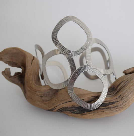 Kyklades Bracelet – handmade Greek hammered jewelry with openwork geometric design, available in 18K gold and silver plated.