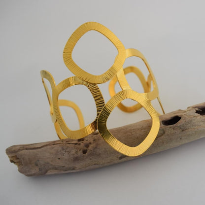 Kyklades Bracelet – handmade Greek hammered jewelry with openwork geometric design, available in 18K gold and silver plated.