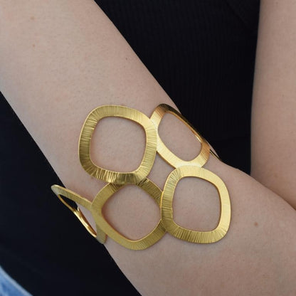 Kyklades Bracelet – handmade Greek hammered jewelry with openwork geometric design, available in 18K gold and silver plated.