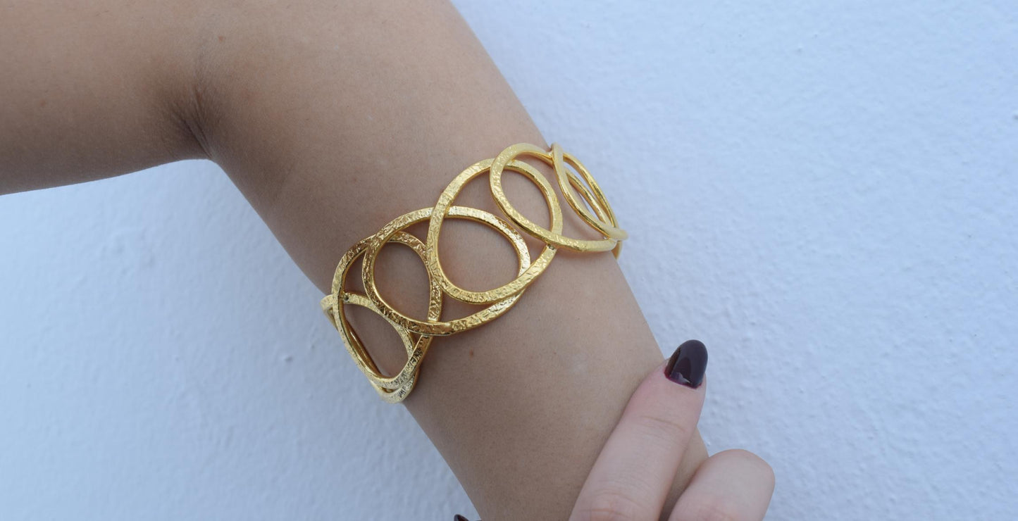 Handmade Hydor bracelet, Greek hammered jewelry in 18K gold or silver plated with flowing openwork sculptural design.