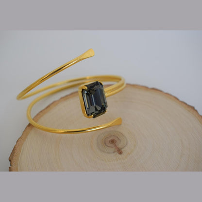 andmade Axon bracelet, Greek hammered jewelry in 18K gold or silver plated featuring a single crystal on a sculptural open cuff.