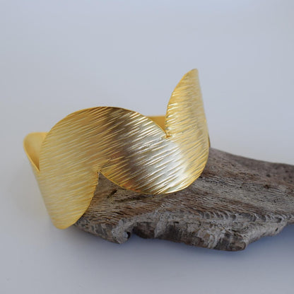 Avgi bracelet, Greek hammered jewelry, available in gold, silver and rose gold plated, with textured wave design.