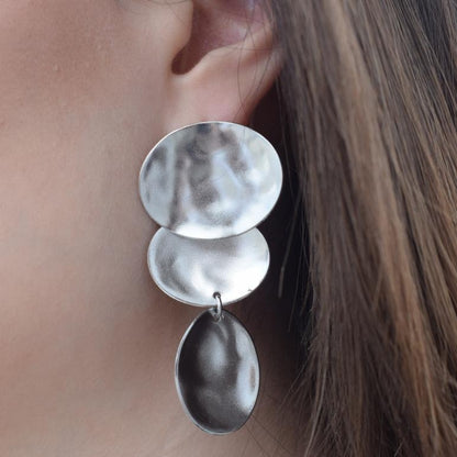 Heliades earrings in handmade Greek hammered jewelry design, available in 18K gold plated and 18K silver plated.