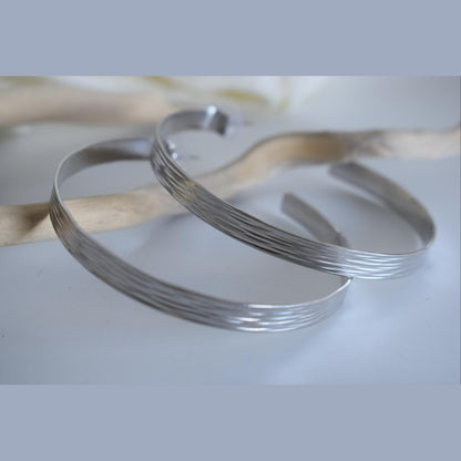 Eos2 earrings in handmade Greek hammered jewelry, featuring open hoop design and available in 18K gold plated and silver plated finishes.