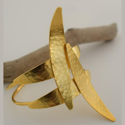 Handmade open cuff bracelet with elongated hammered spear-like elements inspired by Nike, the ancient Greek goddess of victory, available in gold, silver, or rose gold plating.