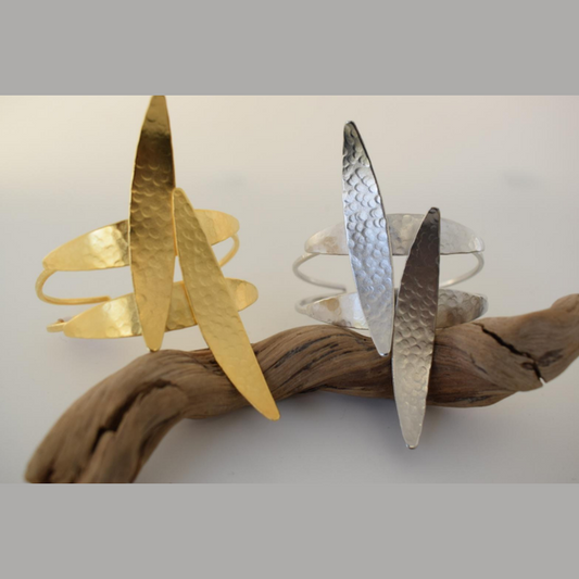 Handmade open cuff bracelet with elongated hammered spear-like elements inspired by Nike, the ancient Greek goddess of victory, available in gold, silver, or rose gold plating.