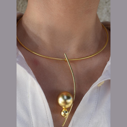 Handmade gold-plated choker necklace with two golden spheres inspired by the cosmos, Greek hammered jewelry design.